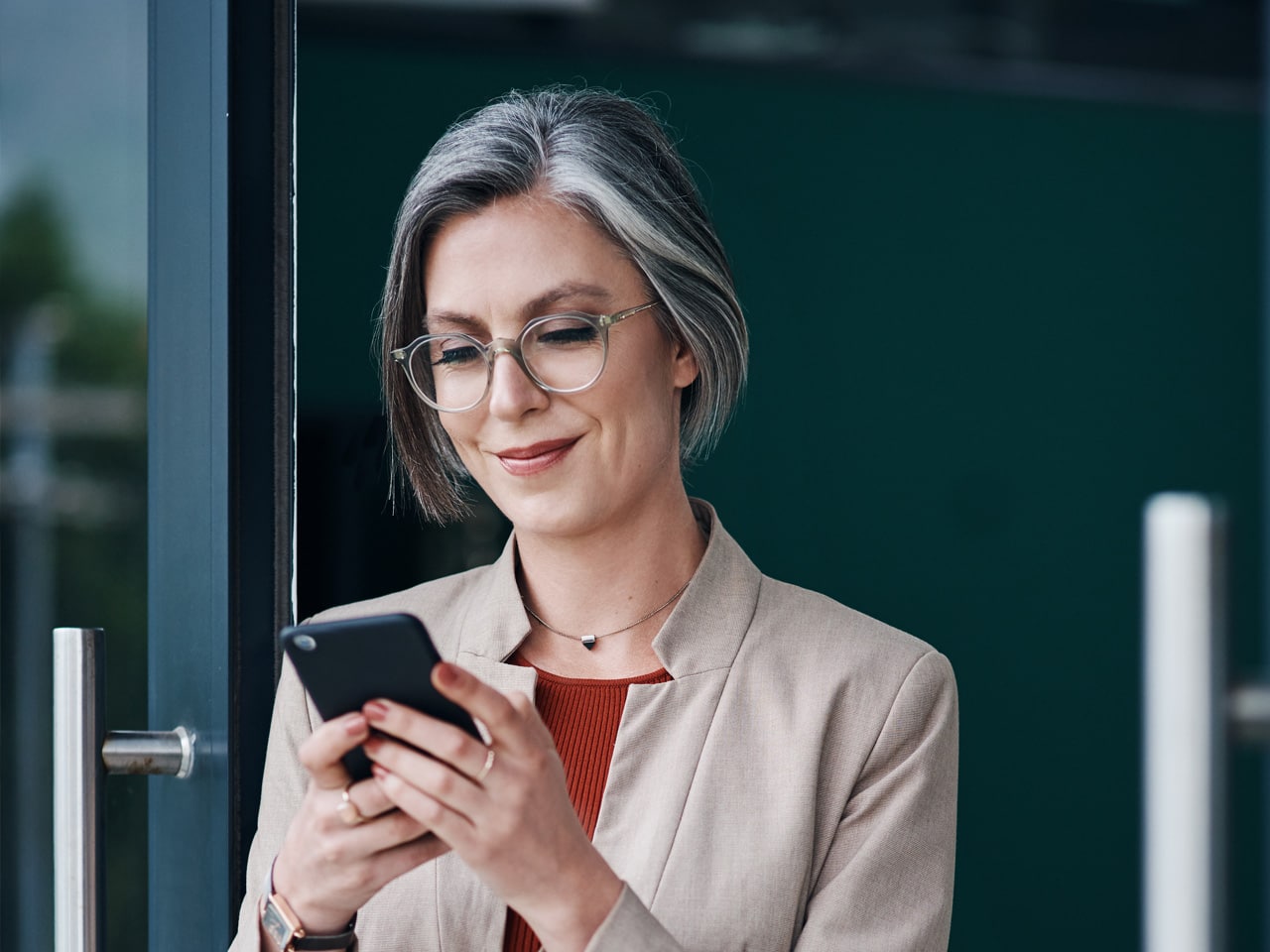 Happy woman leaves five-star google reviews on her phone