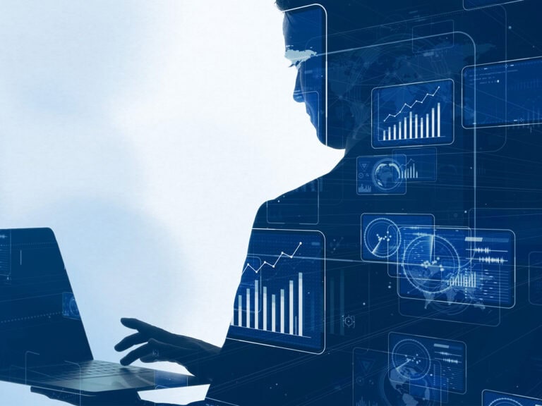 Person on laptop with graphs and charts being displayed