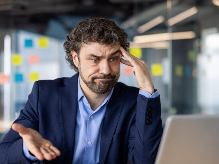 Frustrated man expressing disappointment while working